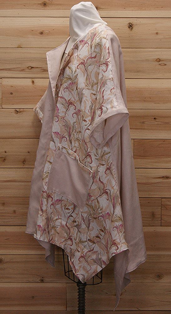 Stylish cloak made of Australian pale pink linen with mauve flowered print and featuring (2) large front pockets.