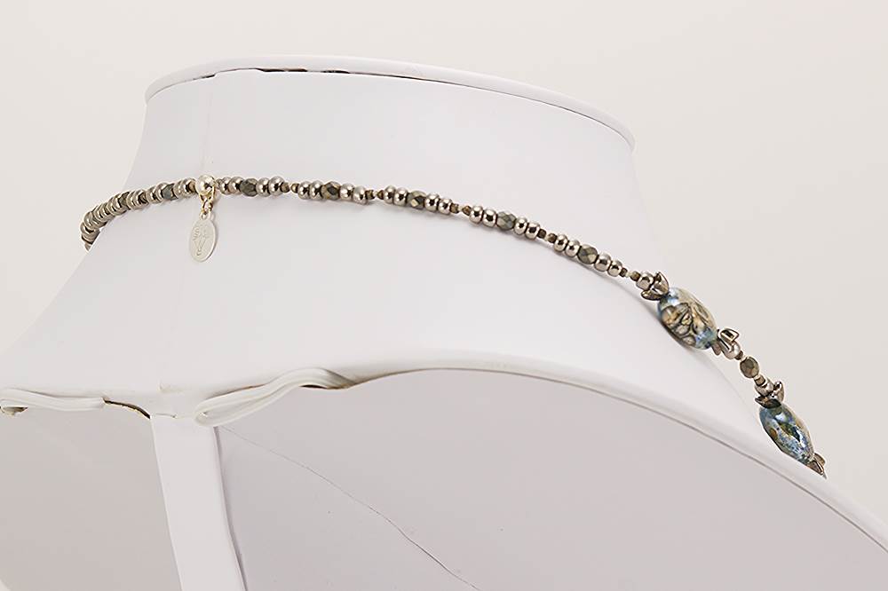 Necklace with grey and ivory colored glass beads.