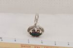 Silver and boulder opal ring with ruler.