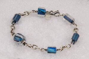 Handmade ocean blue bead bracelet with sterling silver chain and clasp.