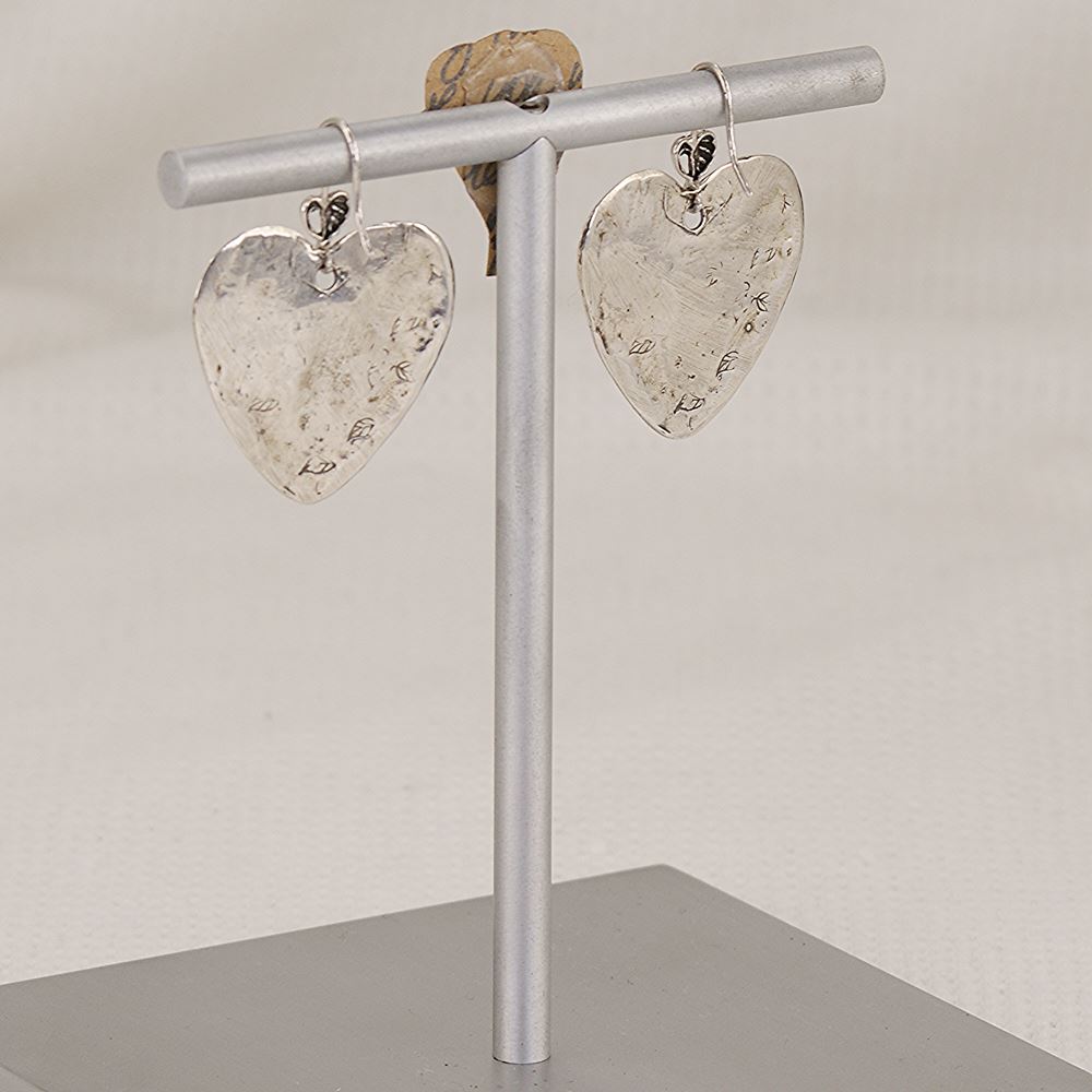 Handmade sterling silver heart and cross earrings with western style .