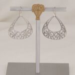 Handmade sterling silver scroll cut earrings.
