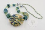 necklace with ocean hued colored glass in blues greens turquoise and soft beige