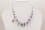 Handmade lavender, violet, heffalump colored glass bead necklace with sterling silver overlay.