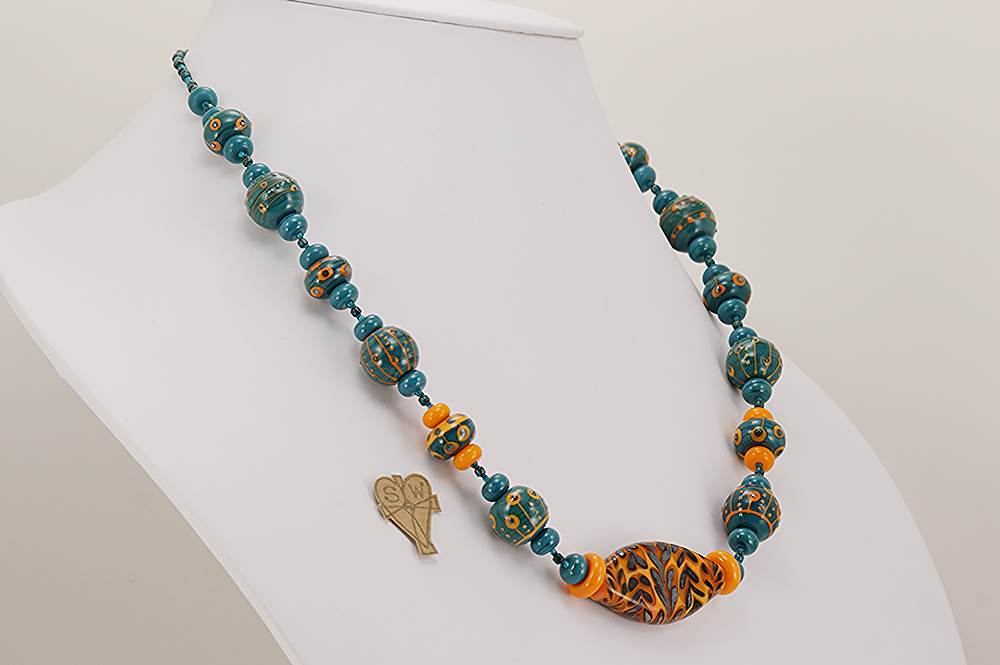 Handmade orange and teal colored glass bead necklace with sterling silver accents.