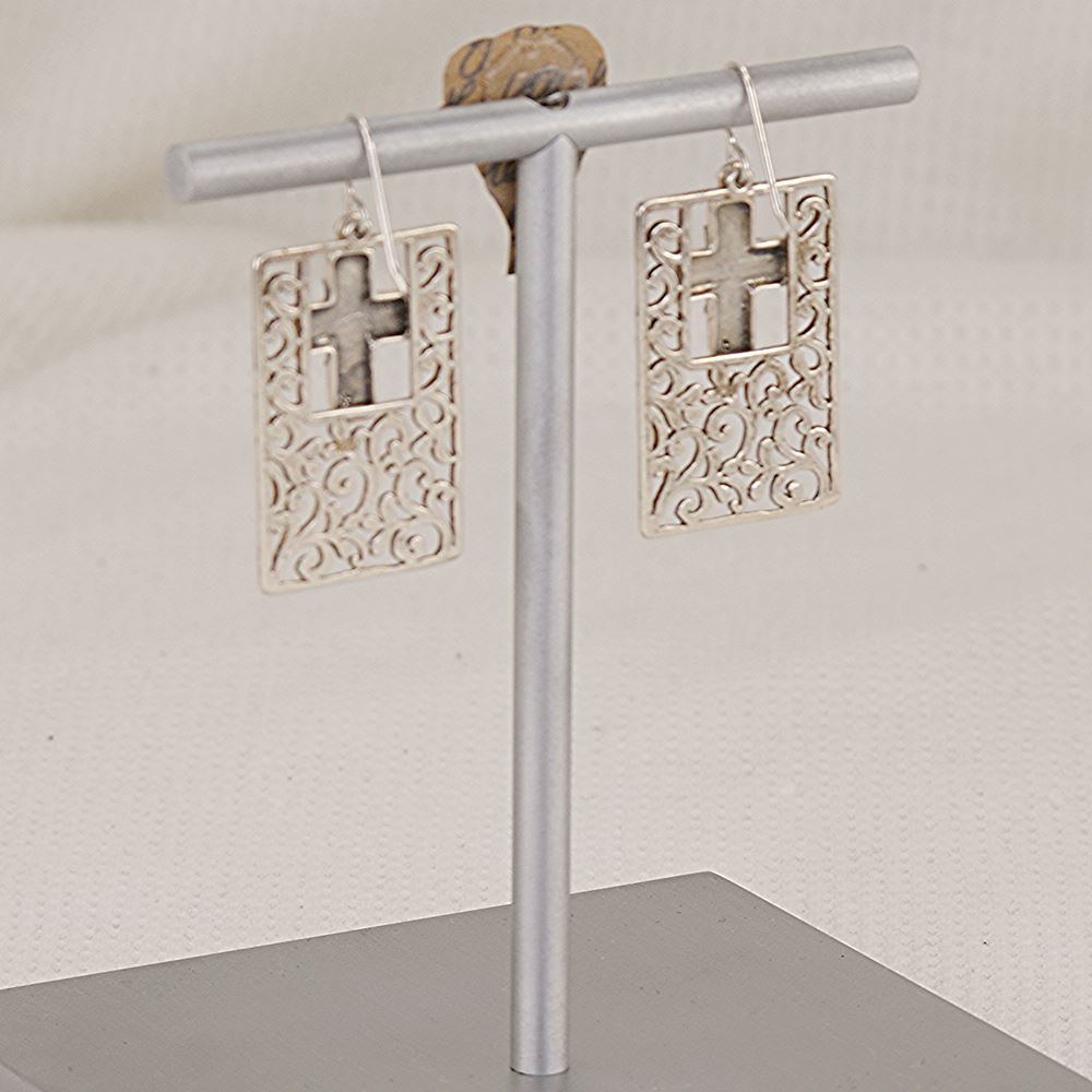 Earrings made of flat scroll cut sterling silver with 3 dimensional crosses.
