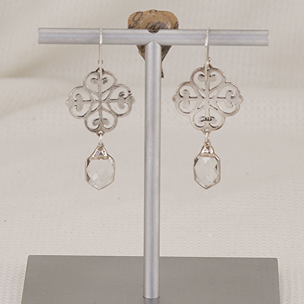 Handmade, solid silver quatrefoil earrings with dangling quartz crystals.