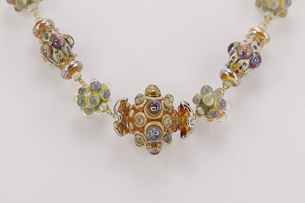 Brown, beige, seafoam green, lavender, silver, glass beaded necklace.