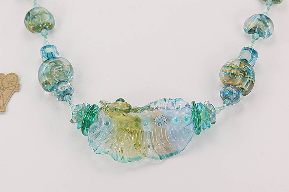 Blue ocean color glass bead necklace with silver and gold dusting .