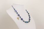 Opalescent blue and purple glass bead necklace.