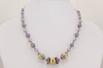 Lavender colored glass bead necklace with 22 karat gold and sterling silver accents.