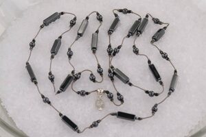 35 inch long, polished hematite necklace.