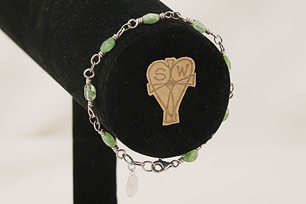 Green rutilated quartz beaded bracelet with sterling silver .