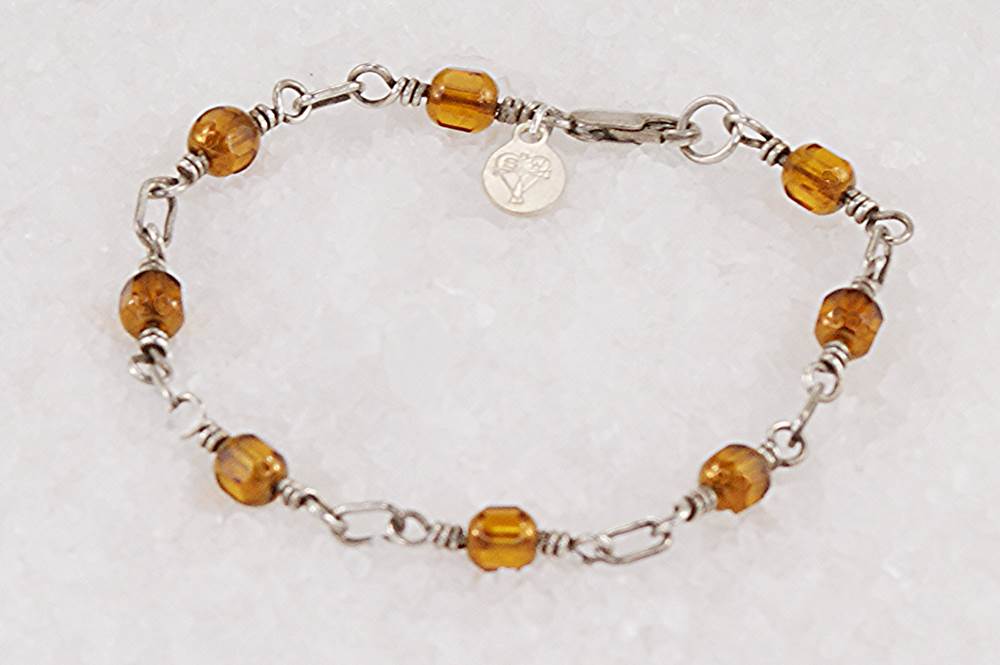 Bracelet handmade with vintage copper colored glass beads and sterling silver