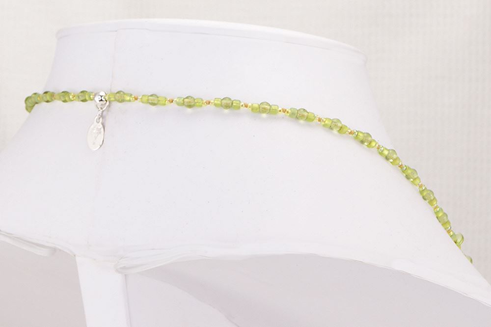 Gorgeous, one of a kind statement necklace made of green and gold blown glass beads.