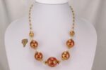Red and gold leaf glass bead necklace with clear quartz discs.