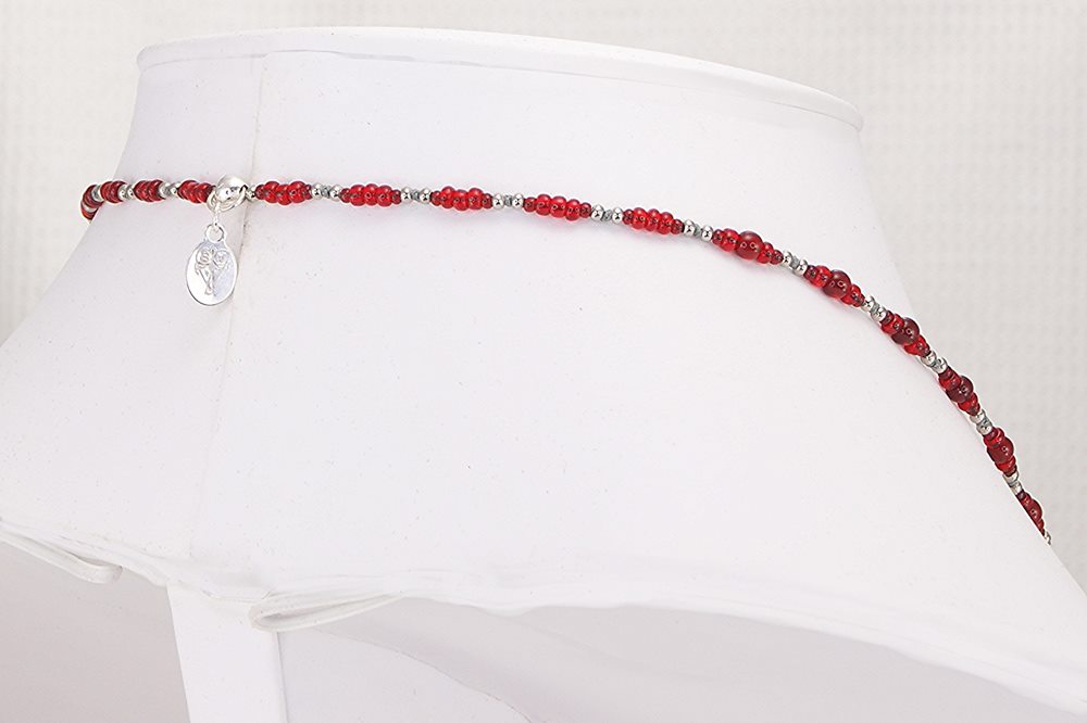 Necklace made of beautiful red glass beads with sterling silver accents.