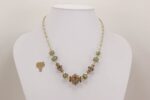 Brown, beige, seafoam green, sterling silver accented glass bead necklace.