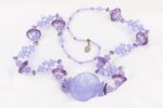 Heffalump and lavender colored glass bead necklace.