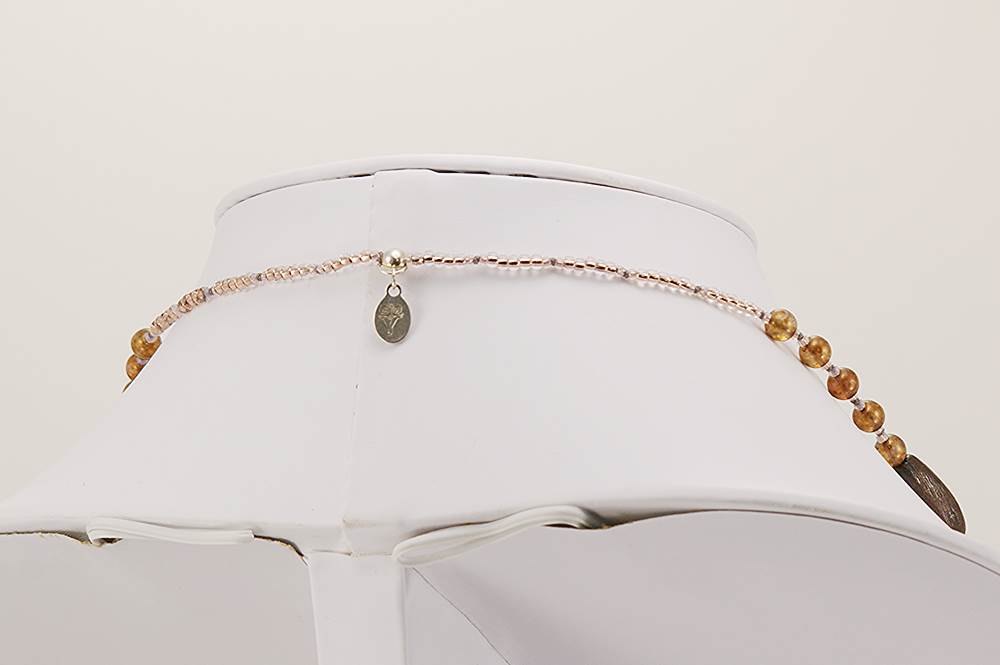 Rust red grey and black colored necklace.