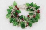 Red and green holly glass bead bracelet on sterling silver chain.