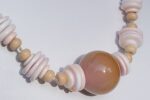Soft pink beaded necklace with conch shell discs.