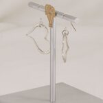 Handmade silver dimensional heart earrings.