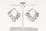 Pleated silver floral earrings.
