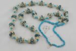 Turquoise and ivory colored glass bead necklace with real turquoise.