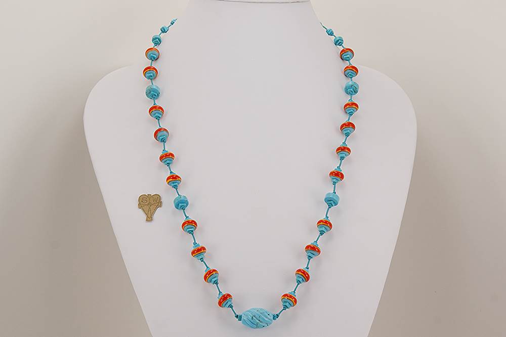 Handmade necklace with turquoise, and reddish orange glass beads.
