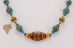Orange and teal colored glass bead necklace with sterling silver accents.