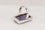 Sterling silver ring with rectangular, purple, charoite crystal.