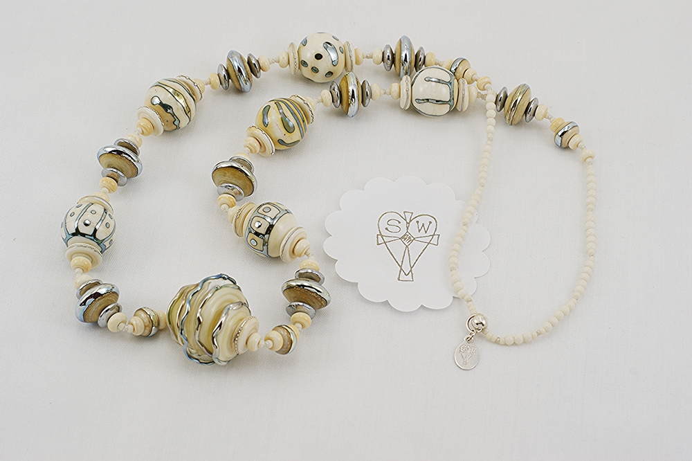 necklace made from ivory colored glass beads with sterling silver accents
