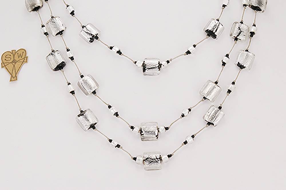 This 3 strand necklace made of sterling silver, black and clear vintage Venetian glass beads.