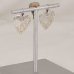 Handmade sterling silver heart and cross earrings with western style .