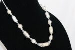 White and beige glass bead necklace with light yellow citrine faceted stones.