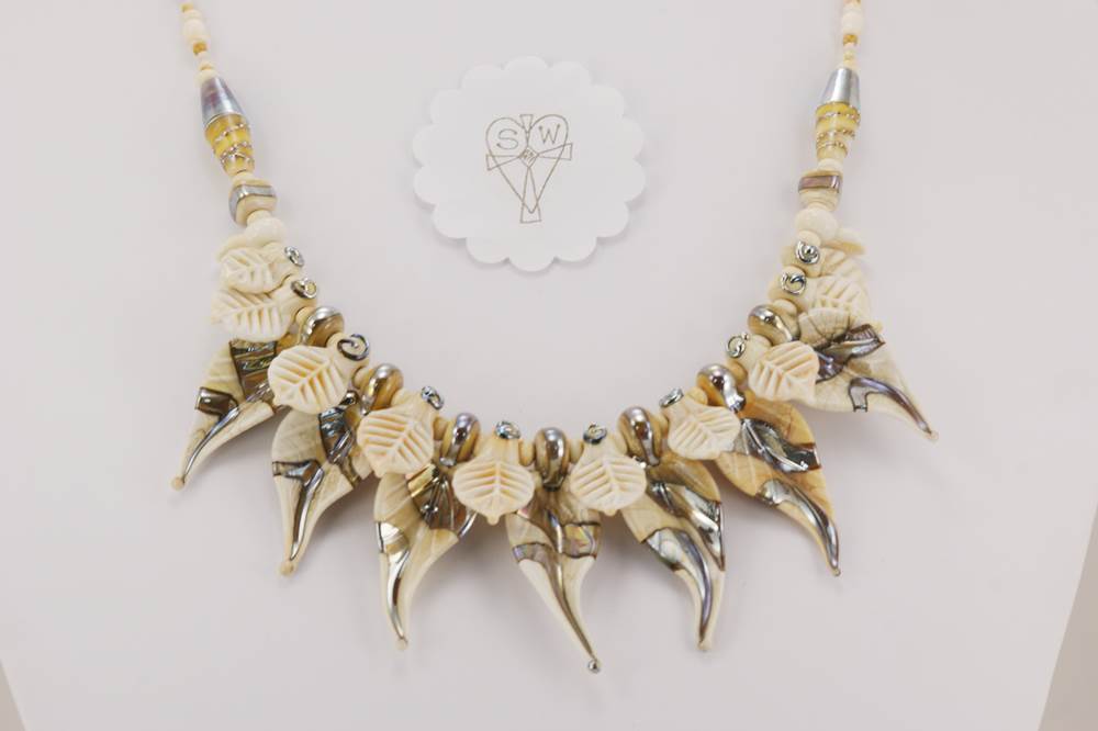 Ivory color with sterling silver accented glass bead necklace.