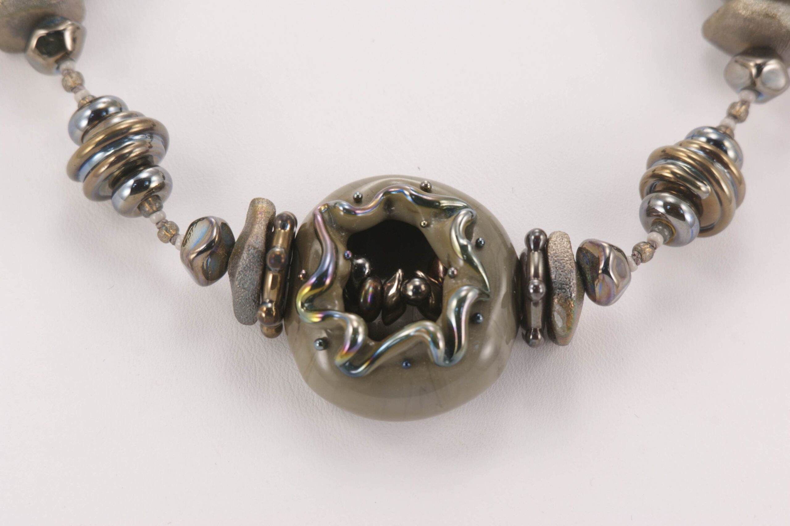 metallic grey glass beaded necklace with sterling silver accents and raku effects.