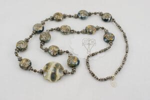 Grey and ivory colored glass bead necklace.