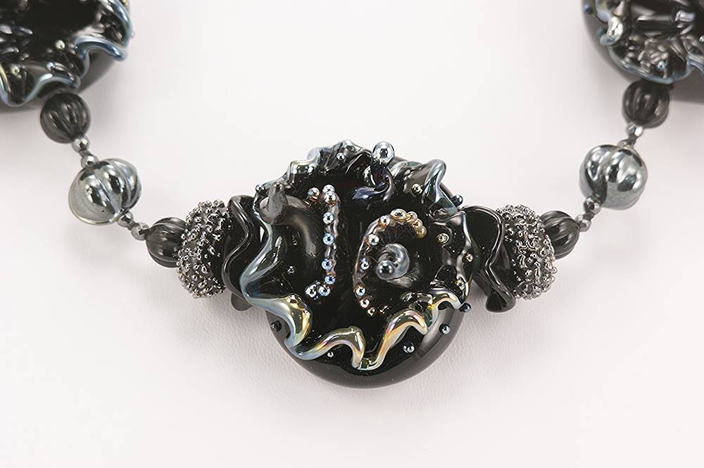 Necklace with black and silver highlighted glass beads.