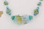 Blue ocean color glass bead necklace with silver and gold dusting .