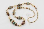 Necklace with chestnut, ivory and teal color glass beads.