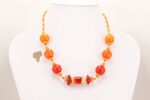 Bright orange and yellow glass bead necklace.