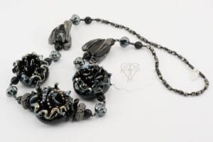 Necklace with handmade black and silver accented glass beads.