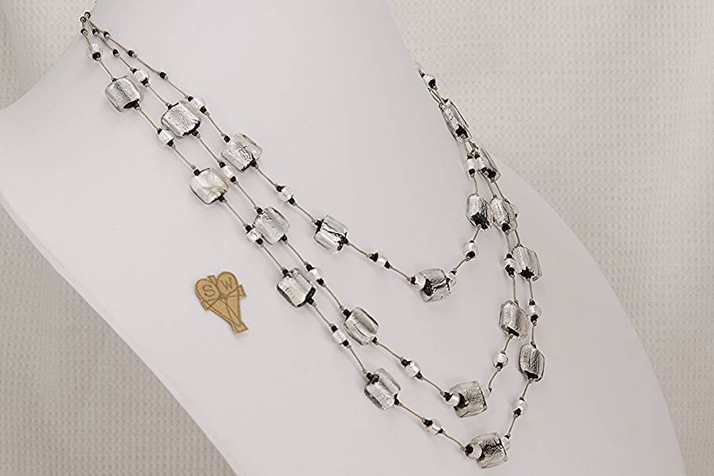 Triple strand necklace with sterling silver gilded, black and clear glass beads.