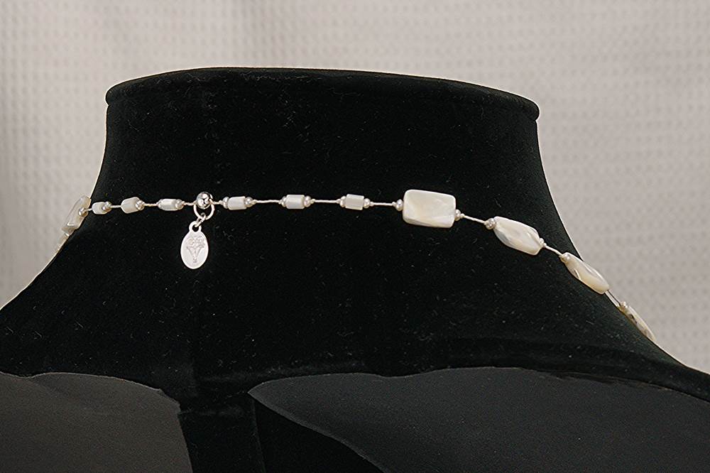 33 inch long mother of pearl and natural pearl necklace.