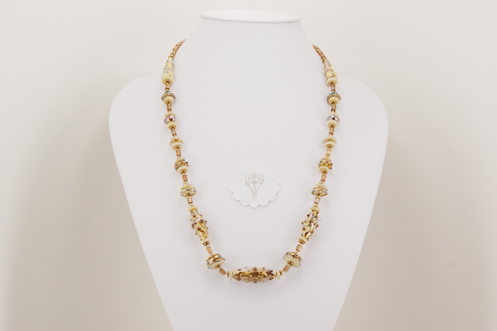 Necklace with ivory colored glass beads high lighted by sterling silver.