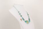 Necklace handmade with blue ocean colored glass beads sparkling with real silver and gold flashing.