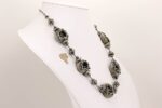 necklace with grey metallic glass beads, sterling silver highlights and raku effect.