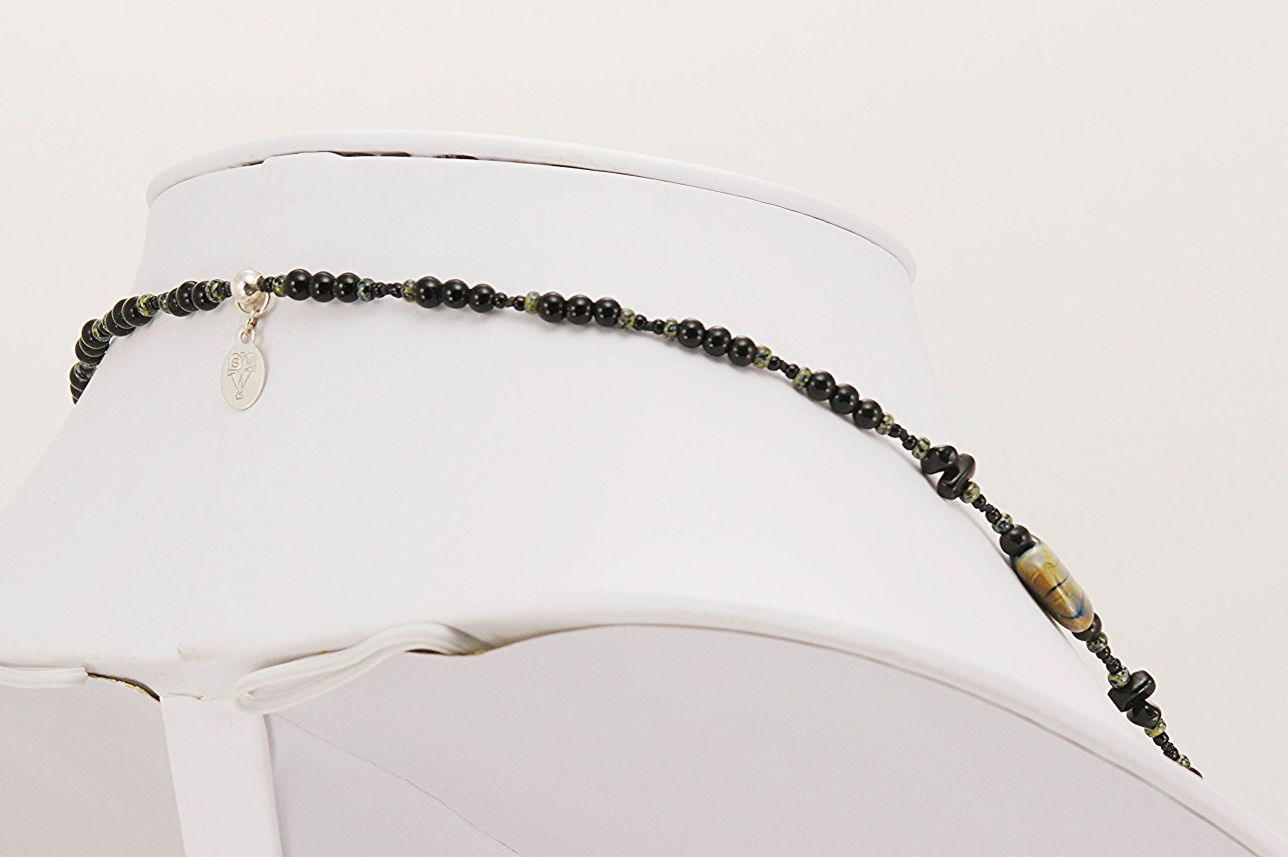 Black, brown and ivory colored glass bead necklace.